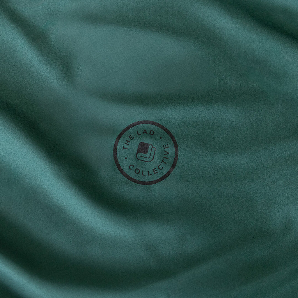 Forest green fabric with a circular logo in the centre.