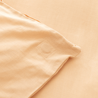 Close-up corner view of peach fabric showing square-stitched corner reinforcement detail