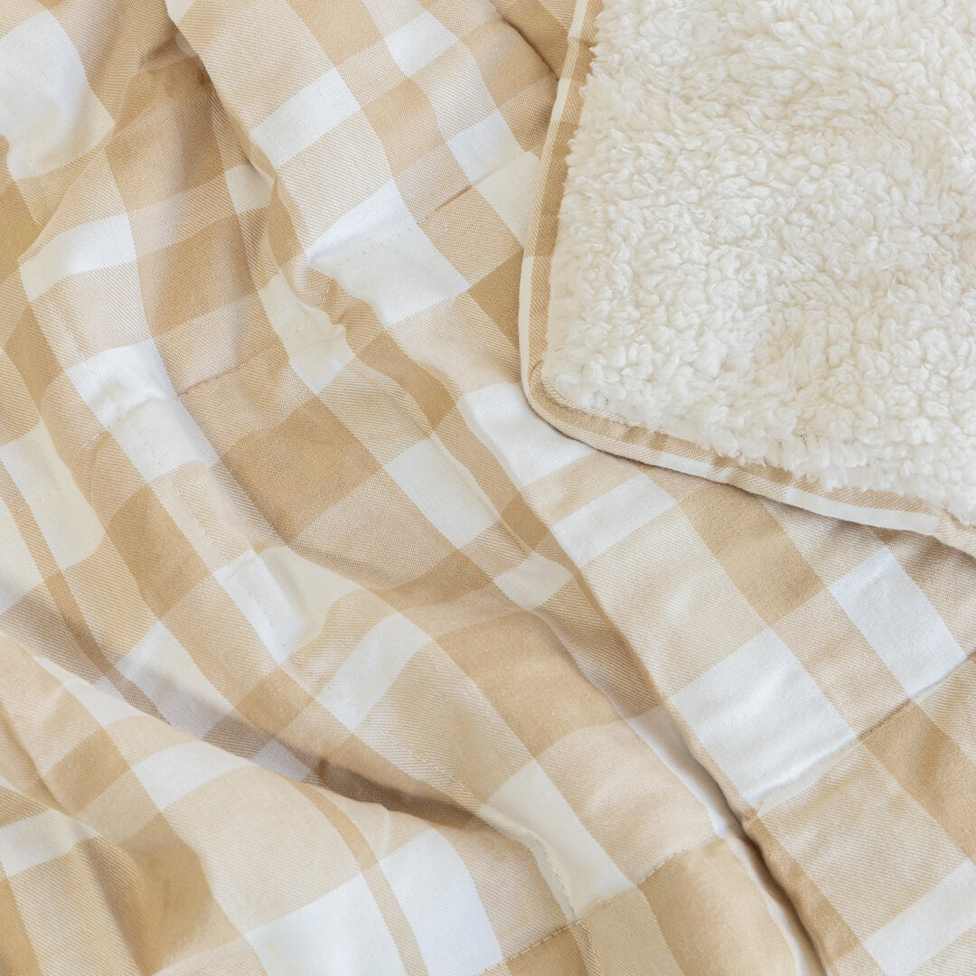 Beige and white checkered blanket with textured wool corner.