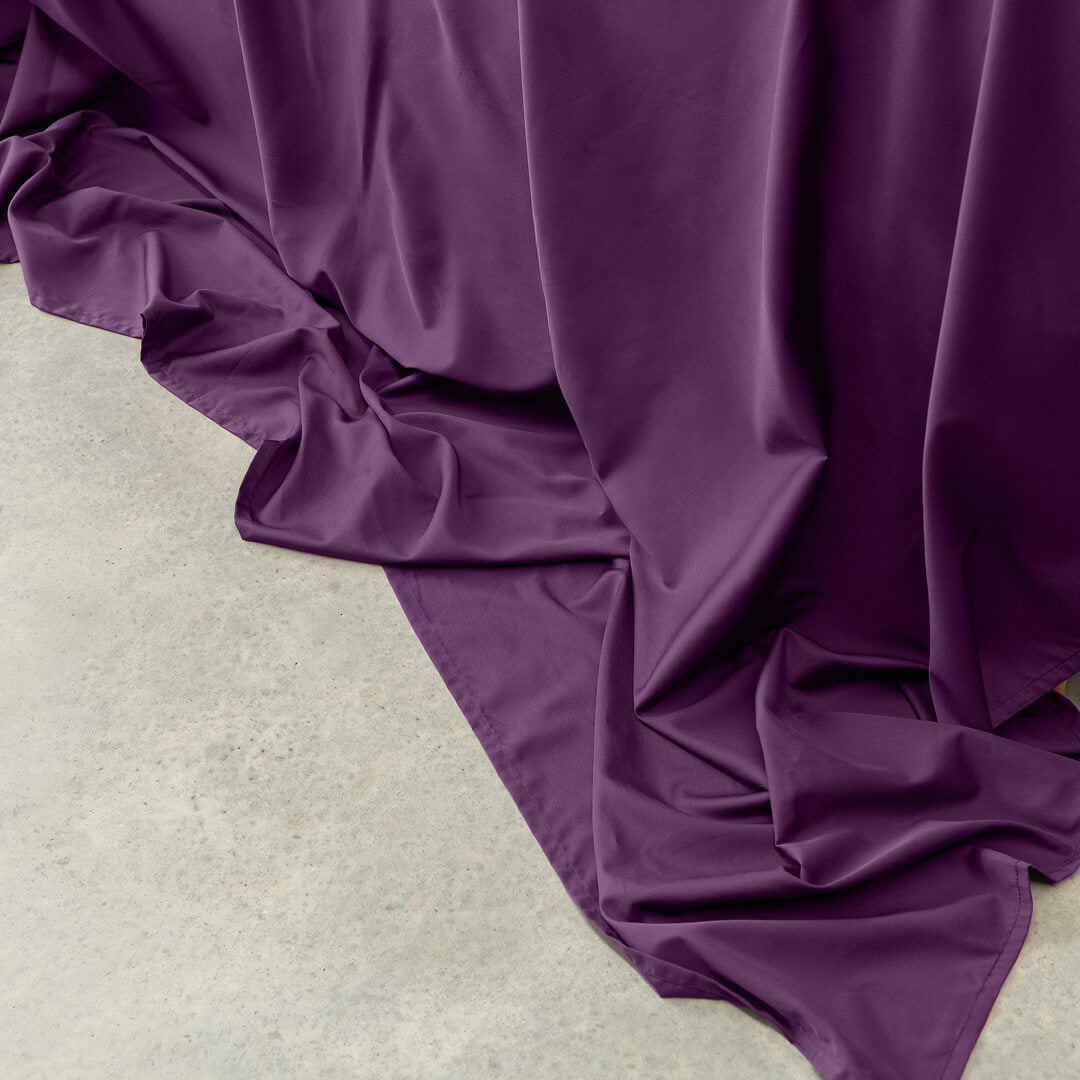 Purple fabric draped over a light-colored surface.