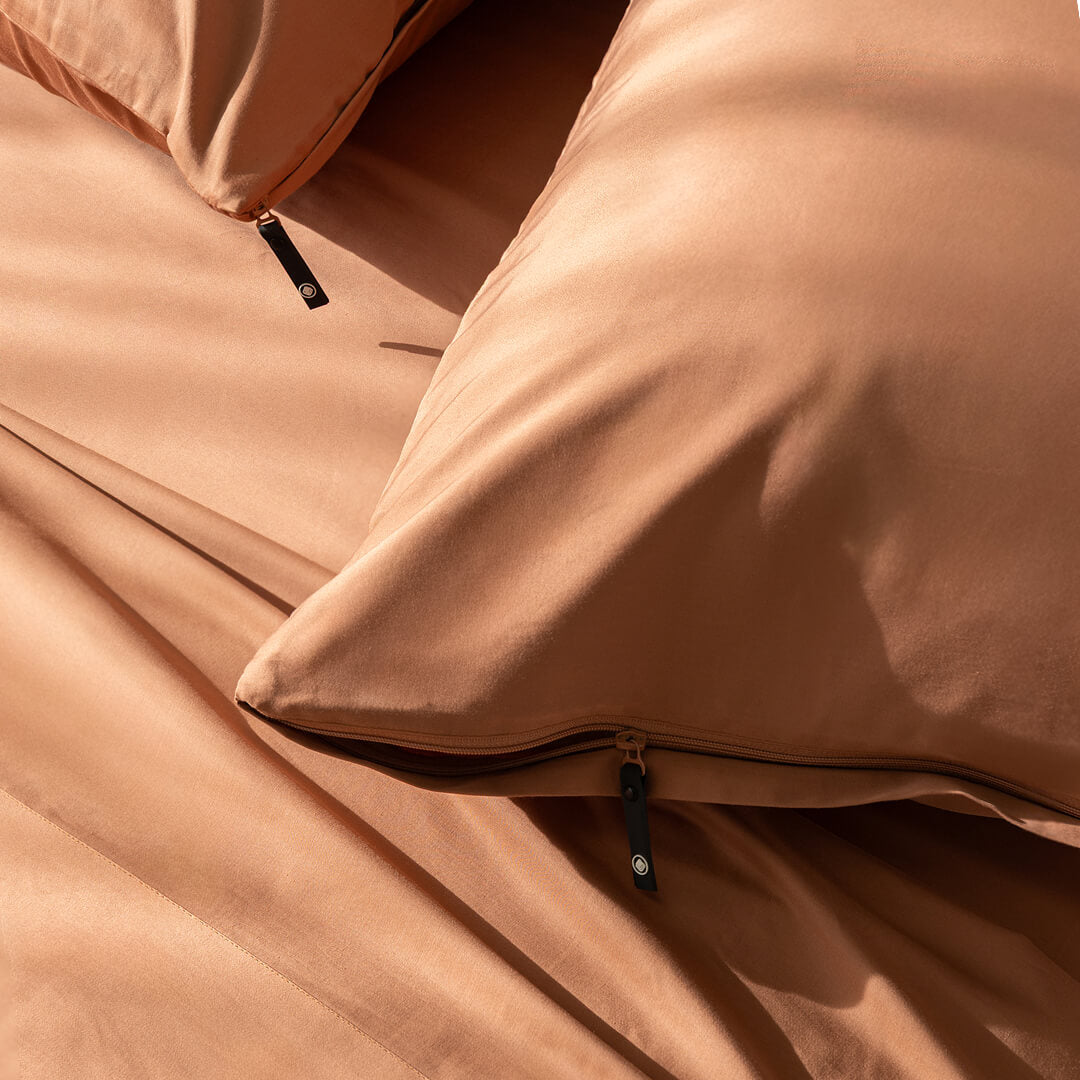 Close-up of a brown pillowcases with a zipper detail.