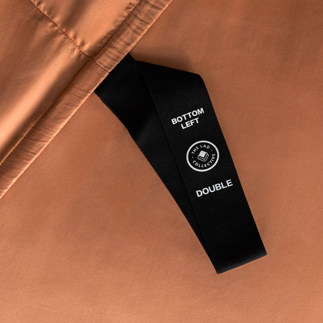 Close-up of a brown fabric with a black label on a matching brown background.