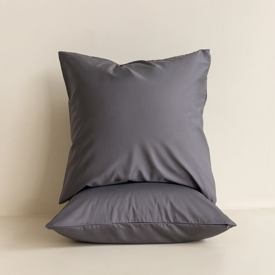Two grey European pillowcases against a neutral background. 