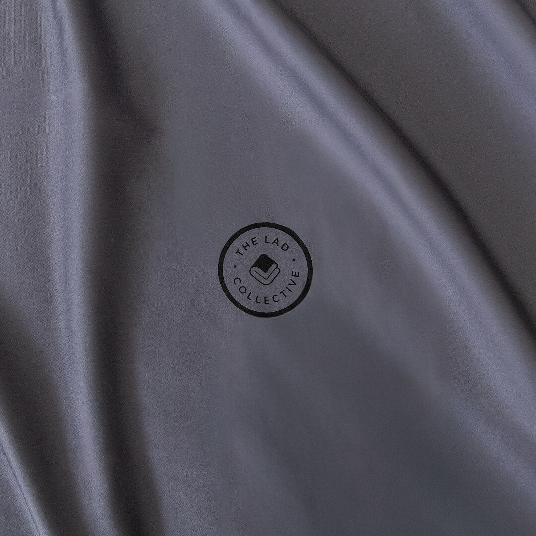 Close-up of a grey fabric with a logo in the center.