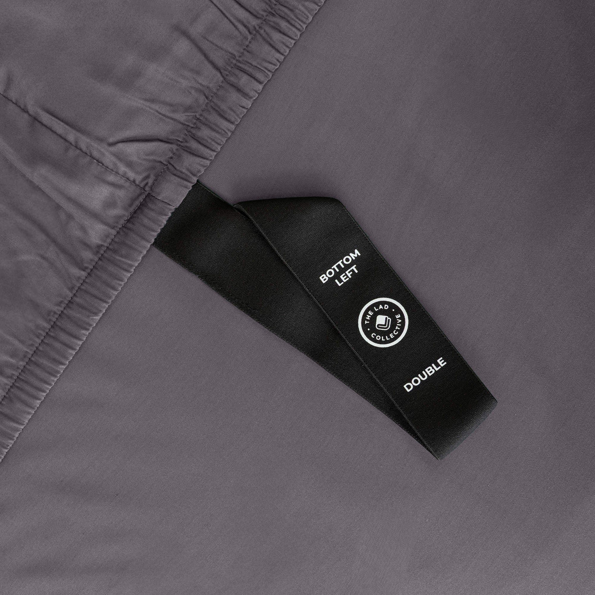 Close up of corner strap in gray bedding