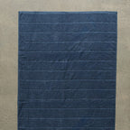 Navy blue textured bath towel laid flat.
