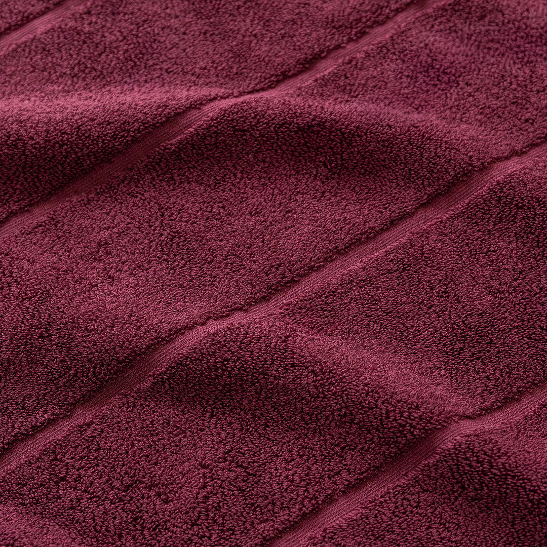 Close-up of maroon fabric with visible texture.
