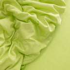 Close-up of crumpled lime green fabric.