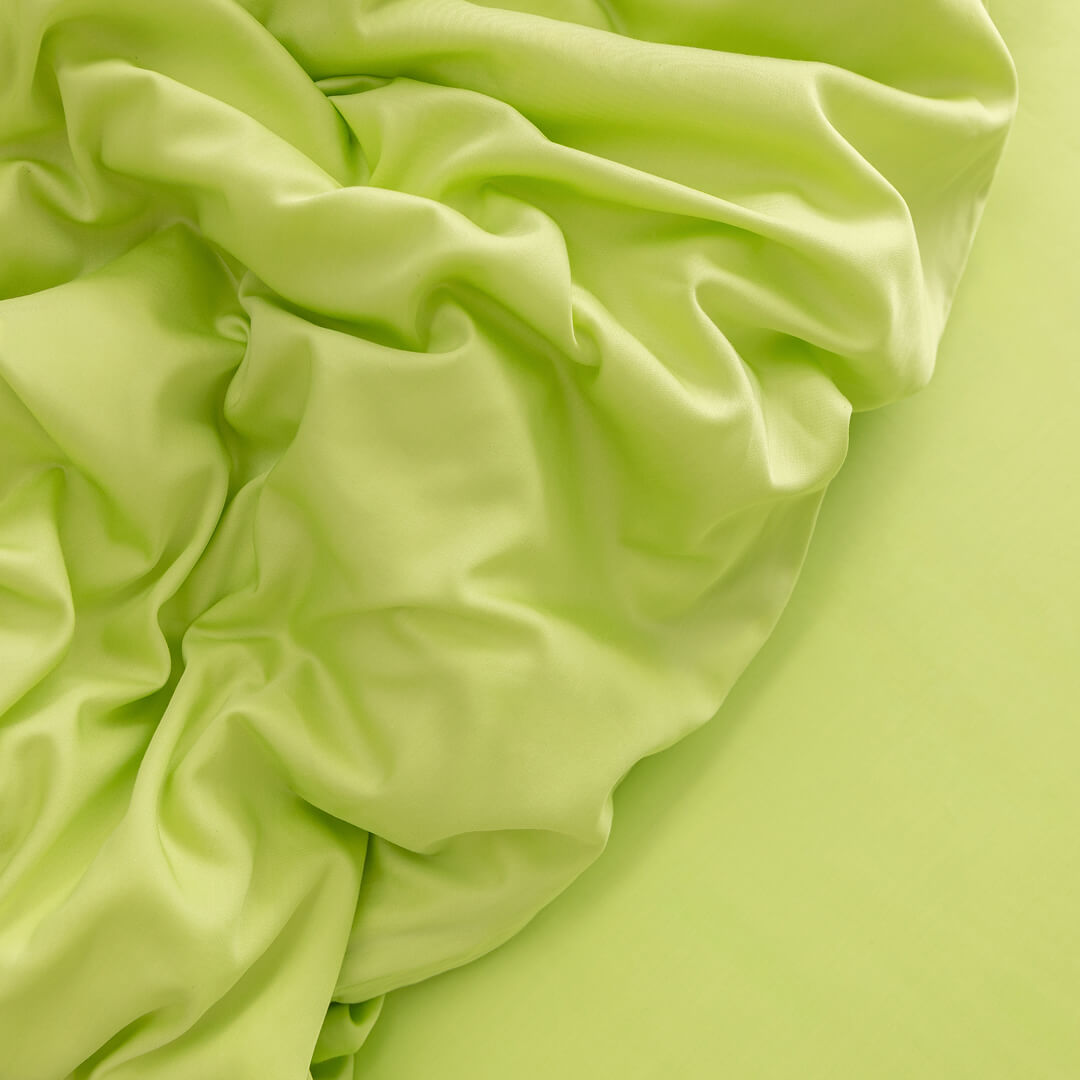 Close-up of crumpled lime green fabric.