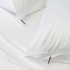 Close up of pillows with zips on white bedding