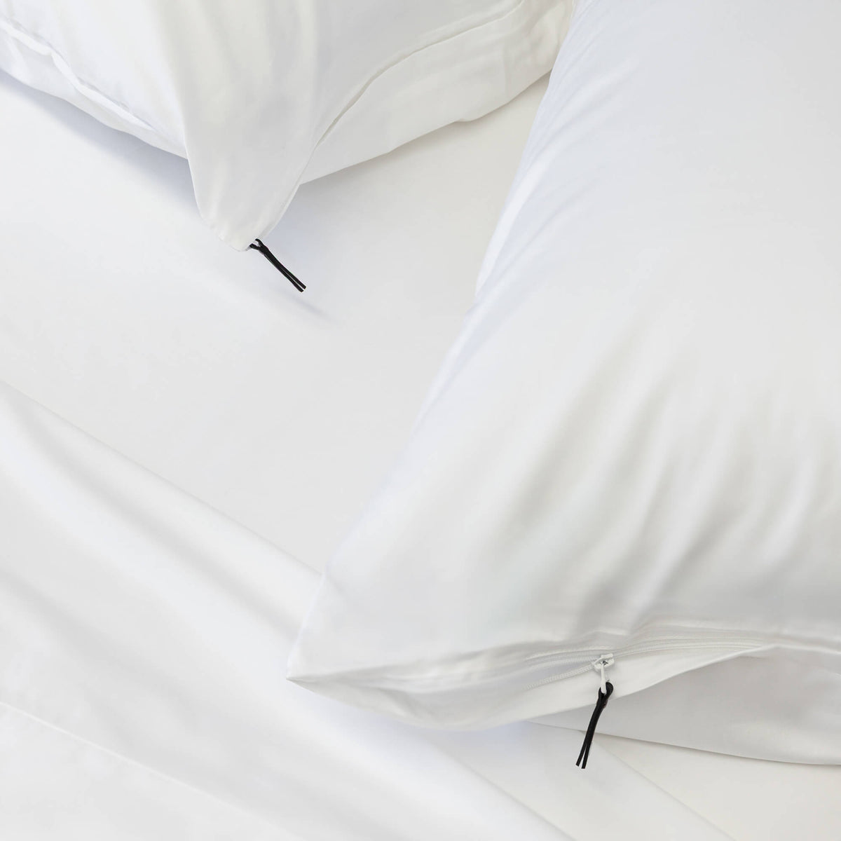 2 white pillows & pillowcases with zip detail