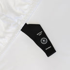 Close up of black corner strap in on white bedding