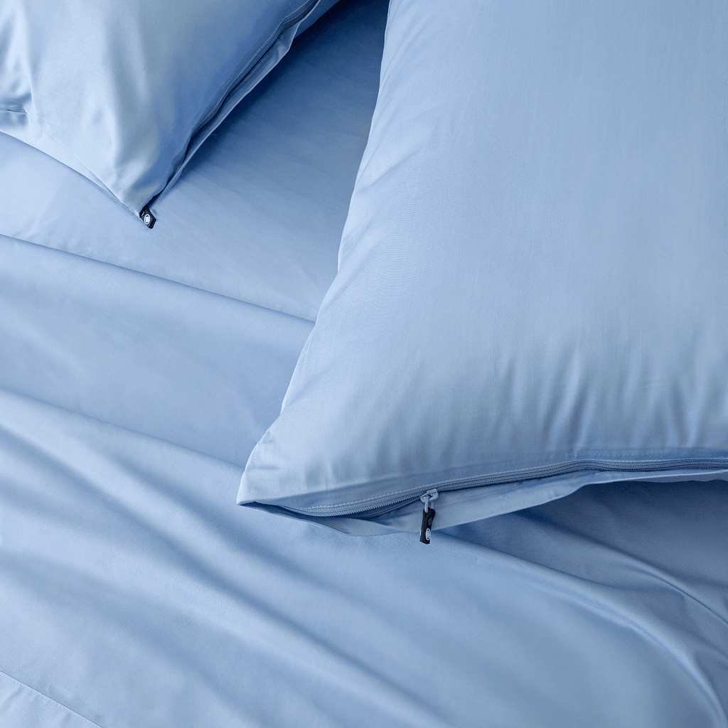 Close-up detail of sky blue pillowcases featuring hidden zipper closures