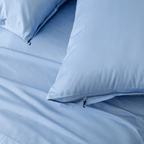 Close-up detail of sky blue pillowcases featuring hidden zipper closures