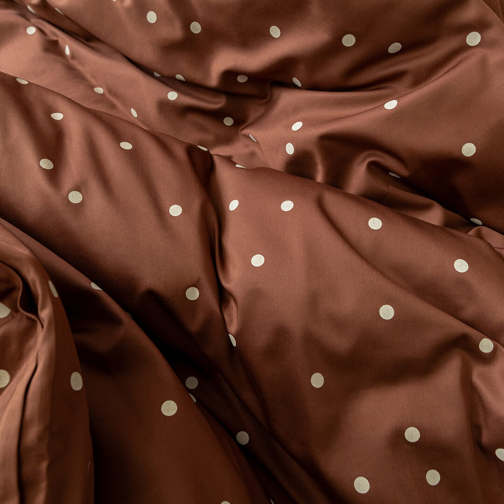 Brown fabric with white polka dots.
