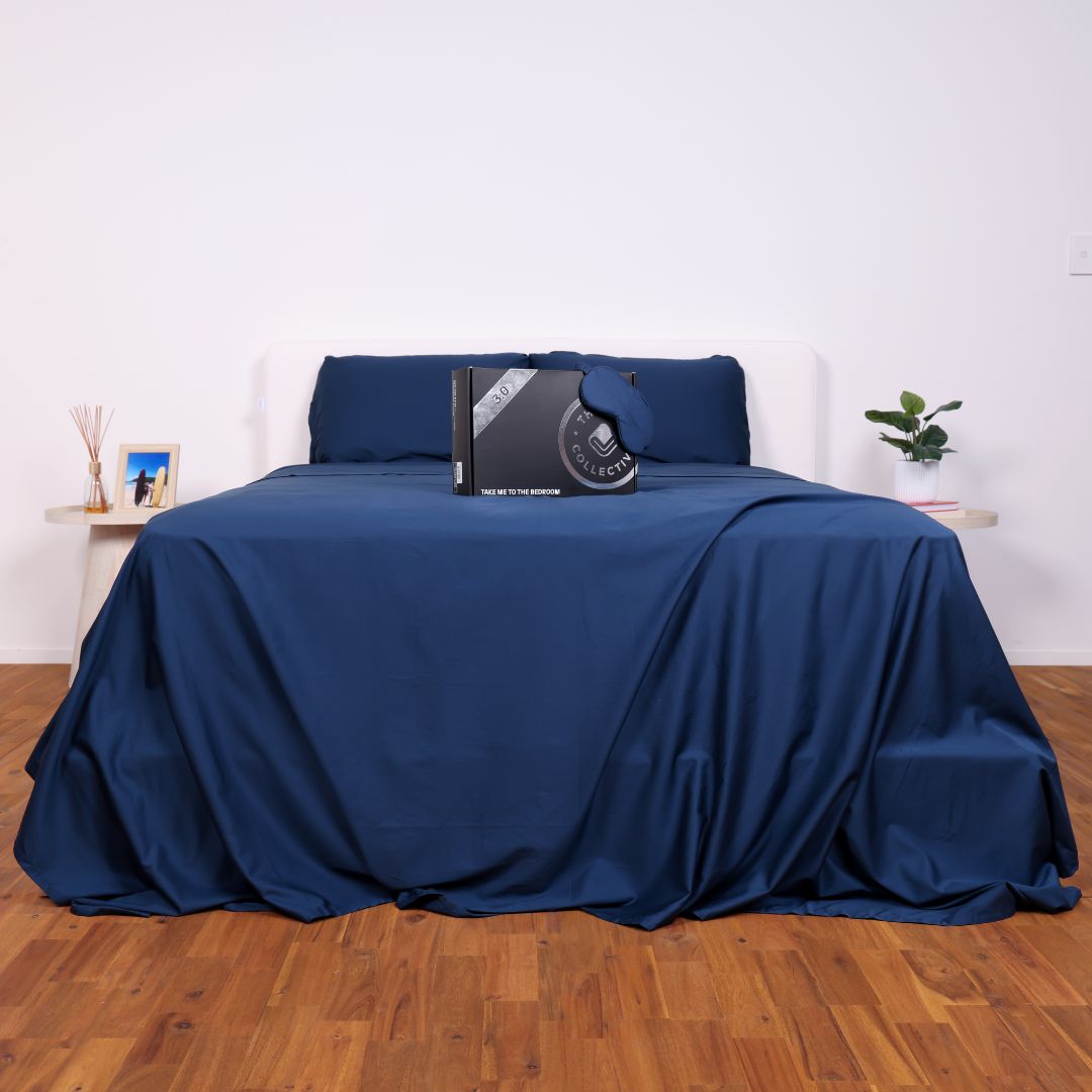 Navy Blue sheets on a bed in a studio 