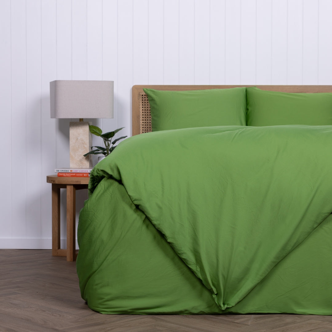 Palm Cove green quilt cover folded at the foot of the bed with crisp styling.