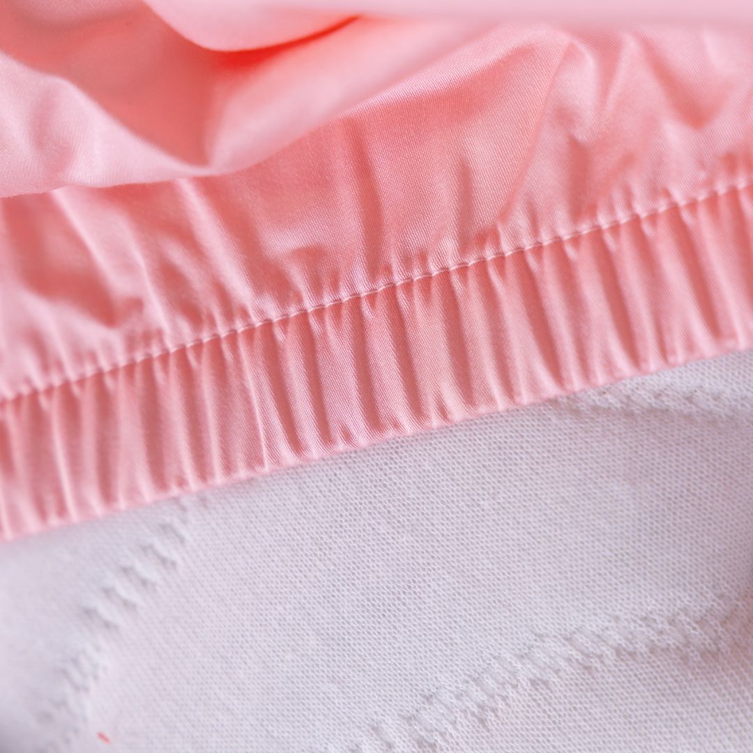 Close-up of Streak Bay fitted sheet elastic on mattress.