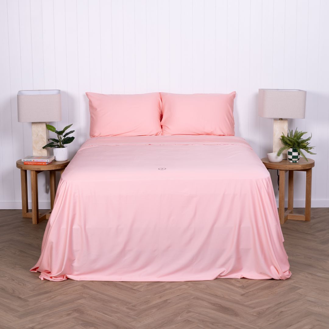 Front-facing view of bed made with pink Streak Bay bedding set.