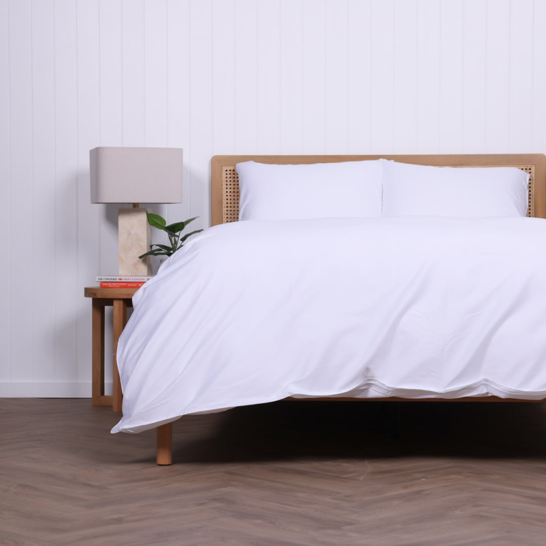 Side angle of Whitehaven duvet set featuring crisp white bedding and minimalist bedroom styling.